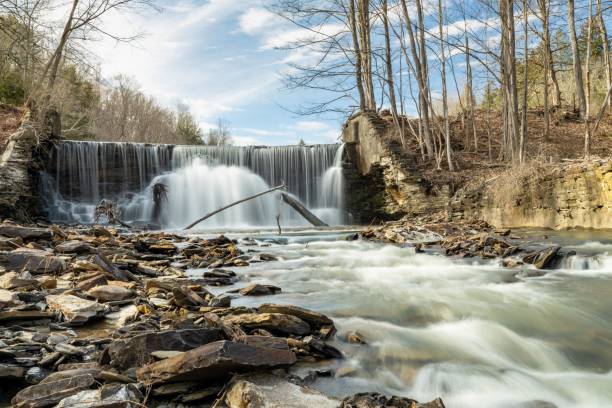 istock Beautiful landscape of a waterfall and stream in a forest 1442904217