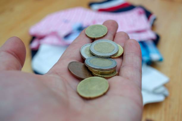 istock paying for clothes with euro coins 1442904576