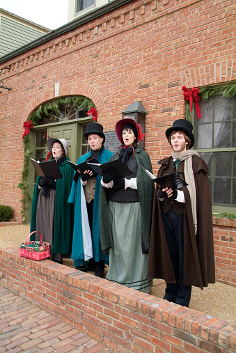 Saint Charles, United States – August 11, 2021: The Victorian era re-enactors at a Christmas holiday singing Christmas carols in St. Charles, Missouri