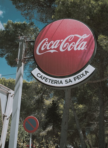 Elvissa, Spain – September 01, 2022: Old and vintage Coca Cola sign from old Mediterranean cafetaria in Ibiza, Balearic Island