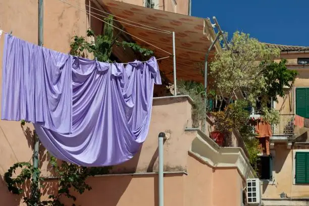 Photo of Drying linens on a rope, historic part of Corfu town in Greece.