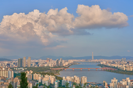 A landscape of the Han River surrounded by modern buildings under the sunlight in Seoul, South Korea