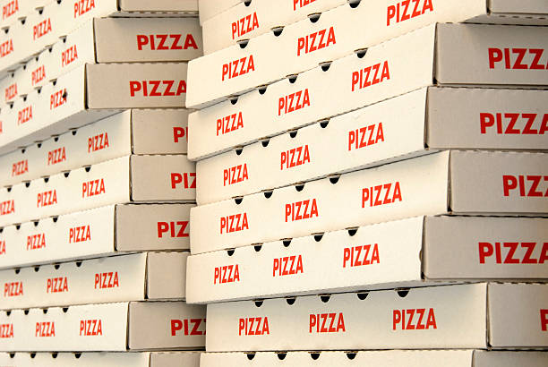 Two stacks of red and white pizza boxes