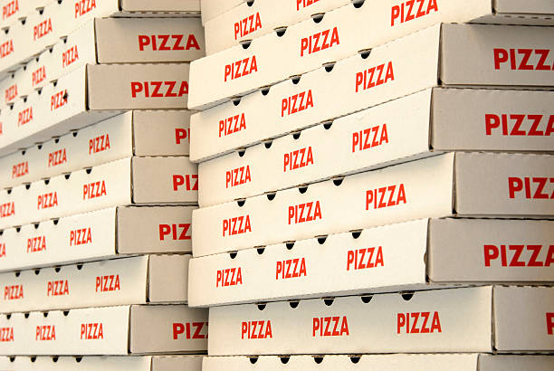 Two stacks of red and white pizza boxes stock photo