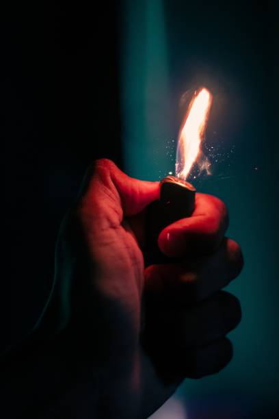 istock Vertical shot of a person hand holding a lit lighter 1442909081