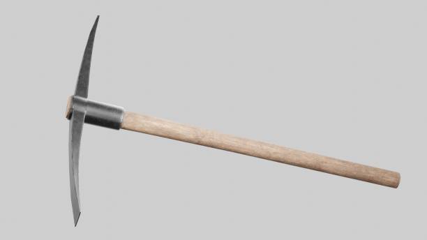 Closeup shot of a pickaxe on the gray background A closeup shot of a pickaxe on the gray background pick axe stock pictures, royalty-free photos & images