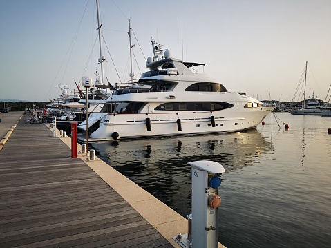 Olbia, Italy – August 16, 2021: A view of luxury yachts at the marina in Olbia at sunset, Italy