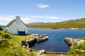 Lakeside cottage and small boat in Connemara, Ireland
