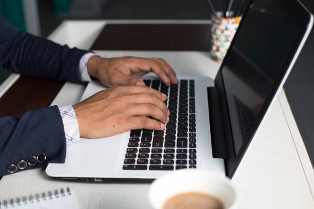 istock Young man in a suit studying or working on a laptop 1442912328
