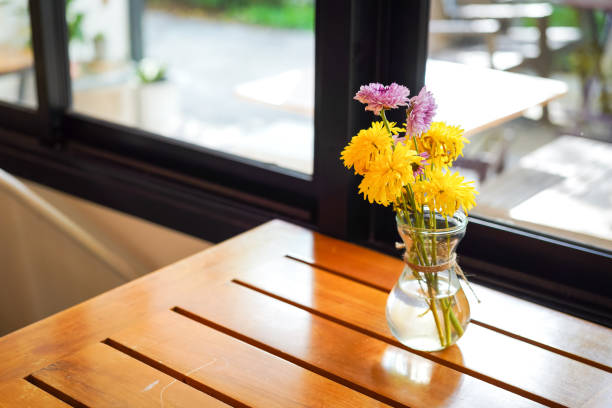 istock A yellow flower in glass vase. 1442912456