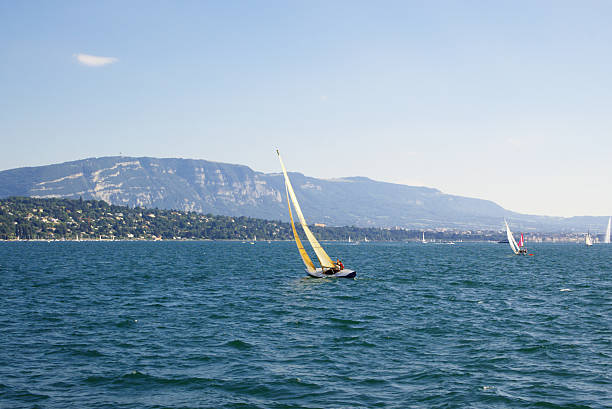 Some yachts in Geneva lake under white clouds. Geneva, Switzerland, EU