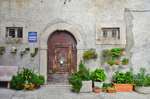 Caramanico Terme, Italy – September 10, 2022: A narrow street between the old stone houses of Caramanico Terme, a medieval village in the Abruzzo region.