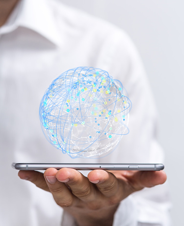 A 3D rendering of a globe with touchpoints on a man's tablet - global connectivity, team conference concept