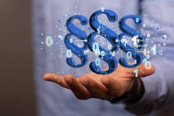 istock Businessman using a 3D rendering of digital paragraph law symbols surrounded by bits and schemes 1442915403