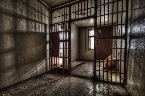 A shot of a prison cell with a lattice door