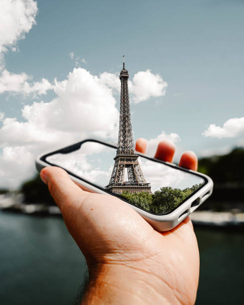 istock Edited montage of the Eiffel Tower emerging from a mobile phone. 1442915918