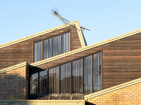 House with asymmetrical saltbox skillion roof. Suburban house architecture.
