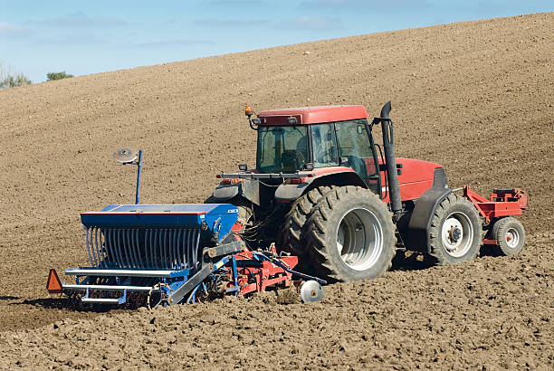 Large red tractor working in the field. stock photo