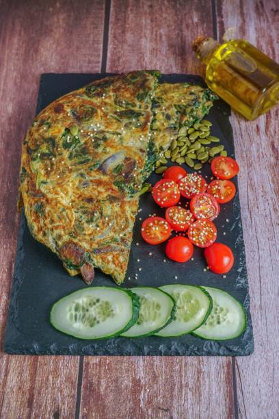 istock spinach stuffed omelet with dried fruits, tomato and cucumber 1442918713