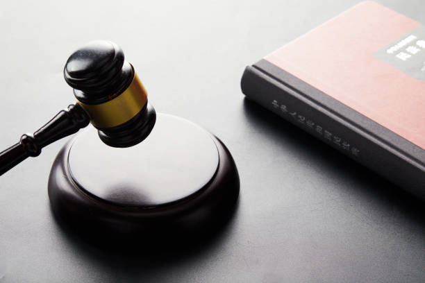 istock Wooden judge hammer with a book on the table 1442920171