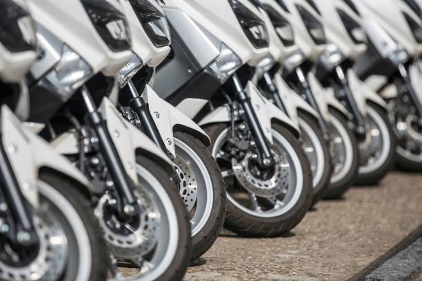 istock mopeds scooters parked in a row on a street. 1442920484
