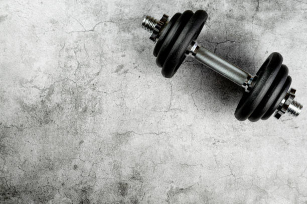 istock Closeup of a dumbbell on a gray surface 1442920582