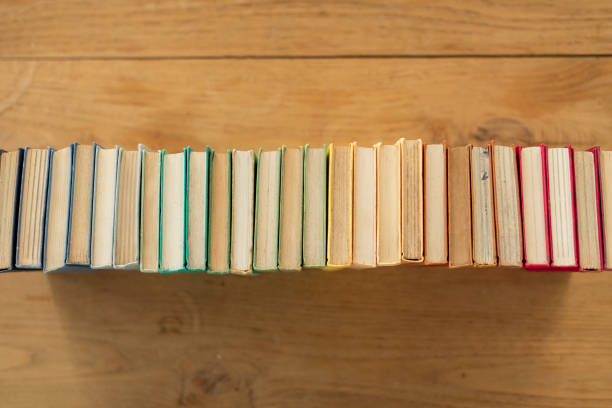 istock Top view of stacked colorful books on different fields on the table 1442921939