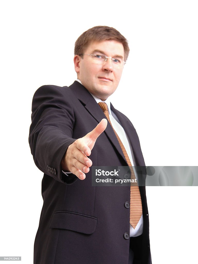 Making a deal Businessman in black suit stretching out hand for handshake over white background Adult Stock Photo