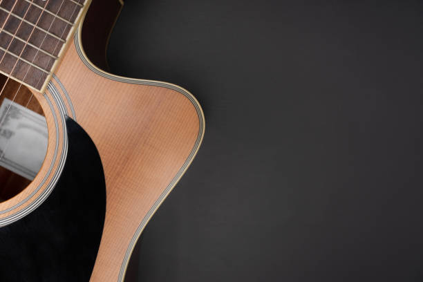 istock old classic guitar on black table background, music concept 1442923167