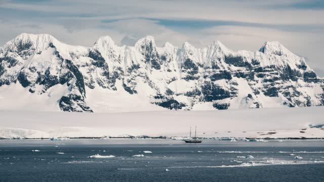 Antarctica, icebergs, view from cruise ship. Amazing beautiful views of Nature and landscape of snow, ice and white of Antarctic. Moving Ice Floes and Ice Sheets in the Antarctic Sea.