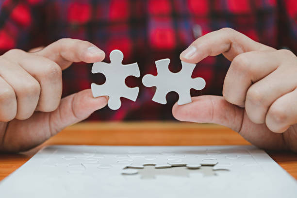 istock Business man use white puzzle piece brainstorming and solution concept, engineer man connect jigsaw puzzle, concept success and strategy, asian young hold jigsaw puzzle. 1442925161
