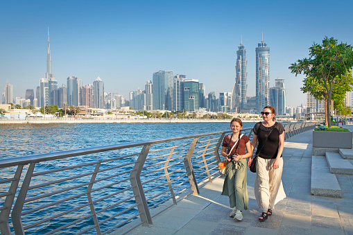 Female tourists walking at Dubai water canal