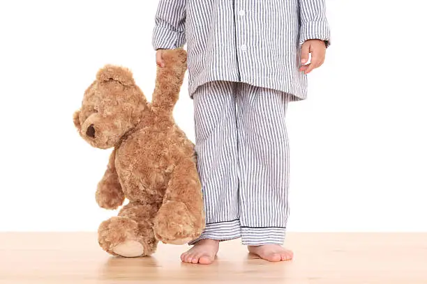 Photo of Little boy with teddy bear trying not to go to bed