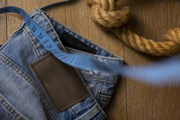 Jeans pant with cord and tape measure Jeans pant with cord and tape measure straight leg pants stock pictures, royalty-free photos & images