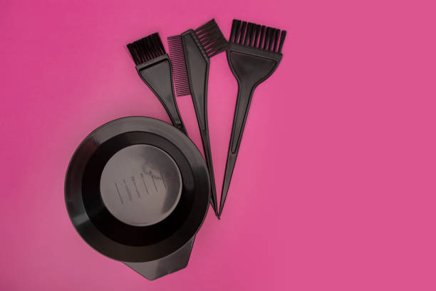 istock hair coloring kit, brushes and a bowl on a pink background, beauty tools, copy space 1442932422