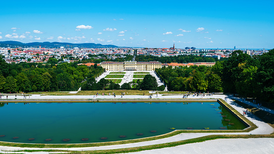 Viena, Austria - August 12, 2022: Panoramic view of Vienna downtown and the Schonbrunn palace from a high viewpoint on a sunny day. Austrian landmark view and its capital city skyline