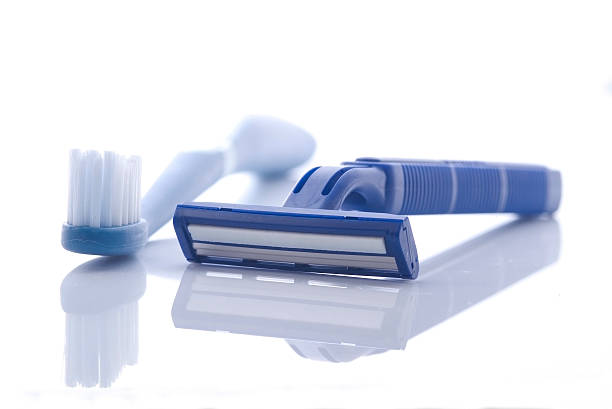 Razor and toothbrush on white stock photo