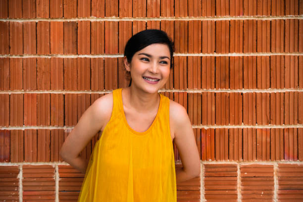 Portrait Smiling confidence Asian woman against brick wall Texture background