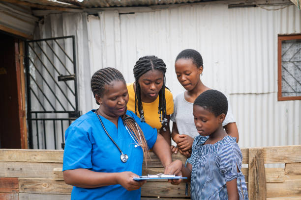 Community Nurse discussion with teenage girls in an informal settlement stock photo