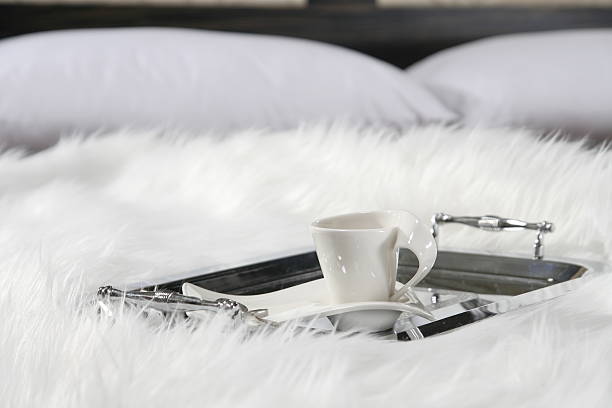 Stylish cup on a fluffy coverlet stock photo