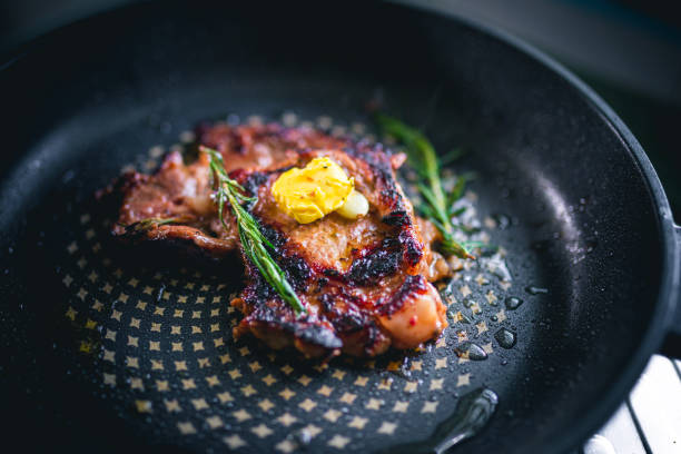 istock Cooked beef steak with rosemary and garlic inside iron skillet 1442939394