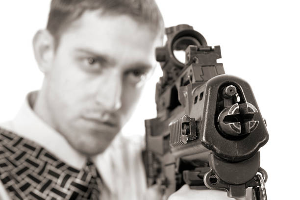 young purposeful manager with dollars in a pocket and weapon stock photo
