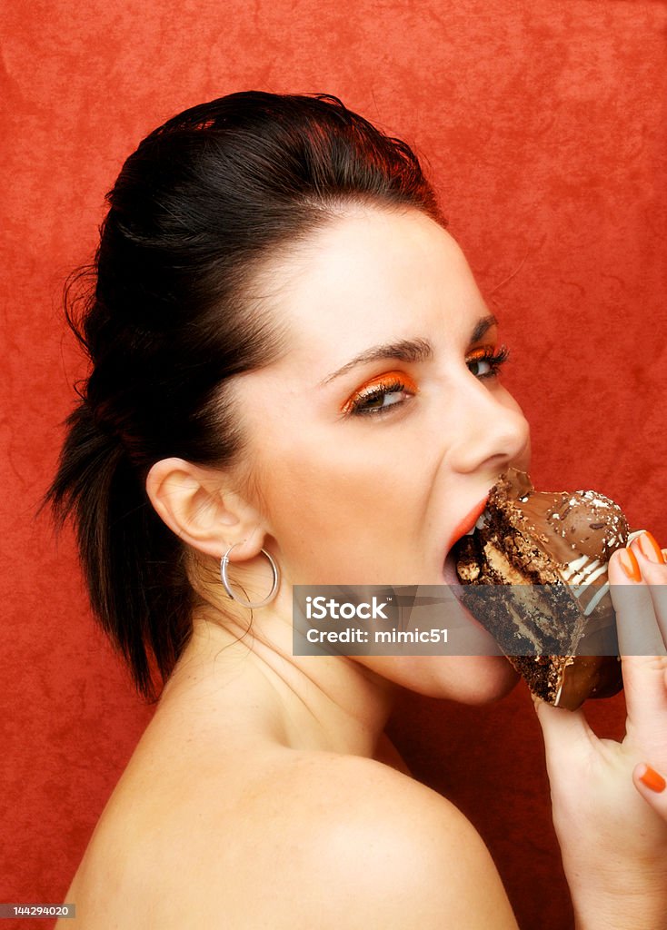 Woman eating cake, Seven Sins Gluttony A woman eating cake. One of the seven sins gluttony 20-29 Years Stock Photo