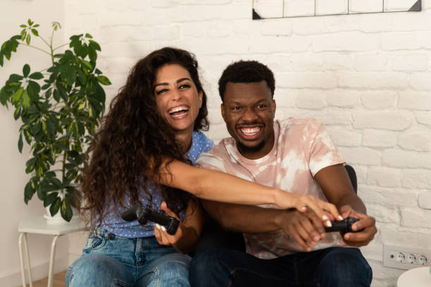 istock Happy multiracial couple gaming and having fun 1442940280