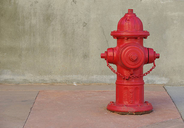 Red fire hydrant on a sidewalk. stock photo