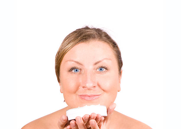 Smiling woman with her favourite cream stock photo