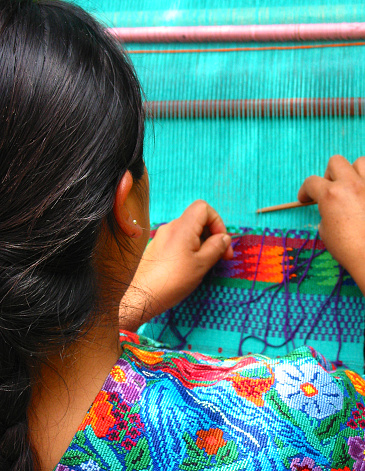 Guatemalan, Mayan woman weaving with hand loom, Antigua, Guatemala