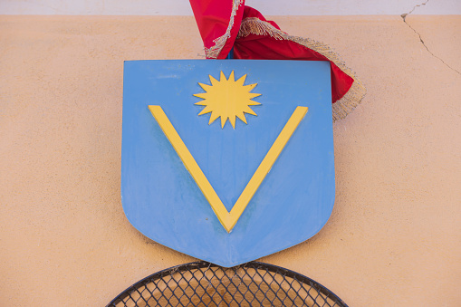 coat of arms of Valensole on the wall of the town hall. Because of the many lavender fields, the town is also known as the capital of lavender; Valensole, France