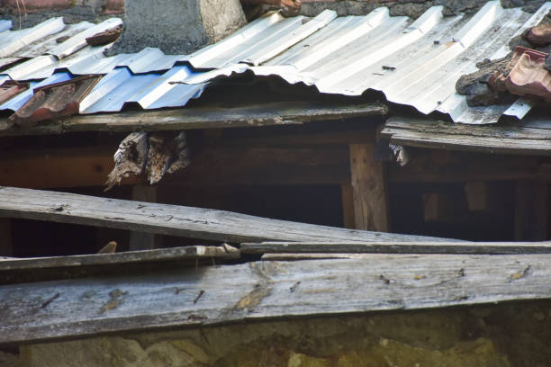Damaged rooftop. Broken and damaged roof tiles