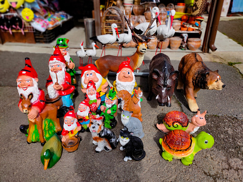 Brasov, Romania - September 26, 2022: Small gnomes and other figurines for the garden - on sale on a road at Brasov, Romania on September 26, 2022.